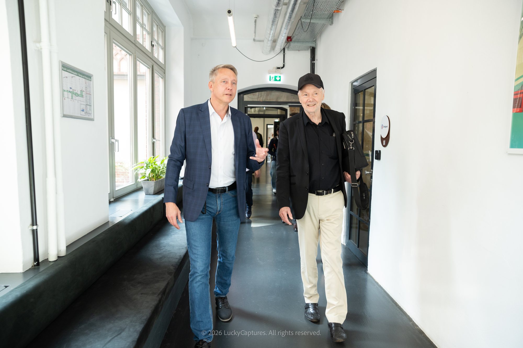 Holger Holland and Prof. Dr. Günter Faltin walking through CIC Berlin
